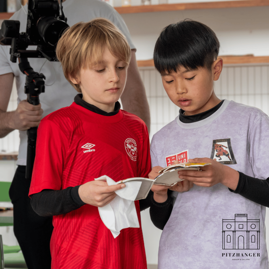 Two boys carefully examine patches for the lion sculpture during the creative session at Pitzhanger Manor & Gallery.