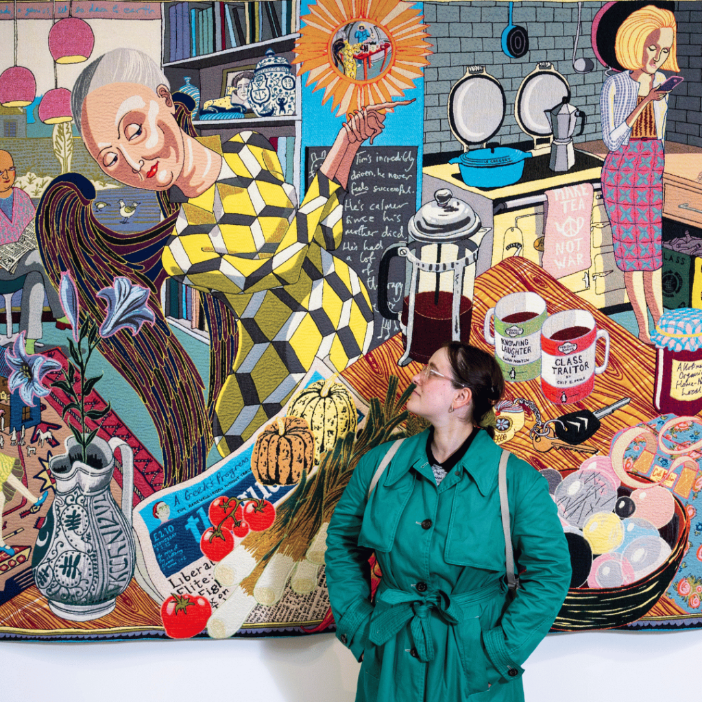 Visitor admiring a vivid, storytelling tapestry featuring eclectic details, showcasing Pitzhanger Manor’s recent contemporary art exhibition.