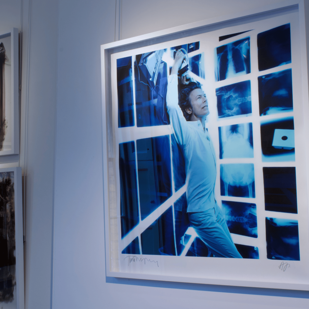 Captivating portrait in vivid blue tones, capturing creativity and energy in the contemporary art gallery setting.