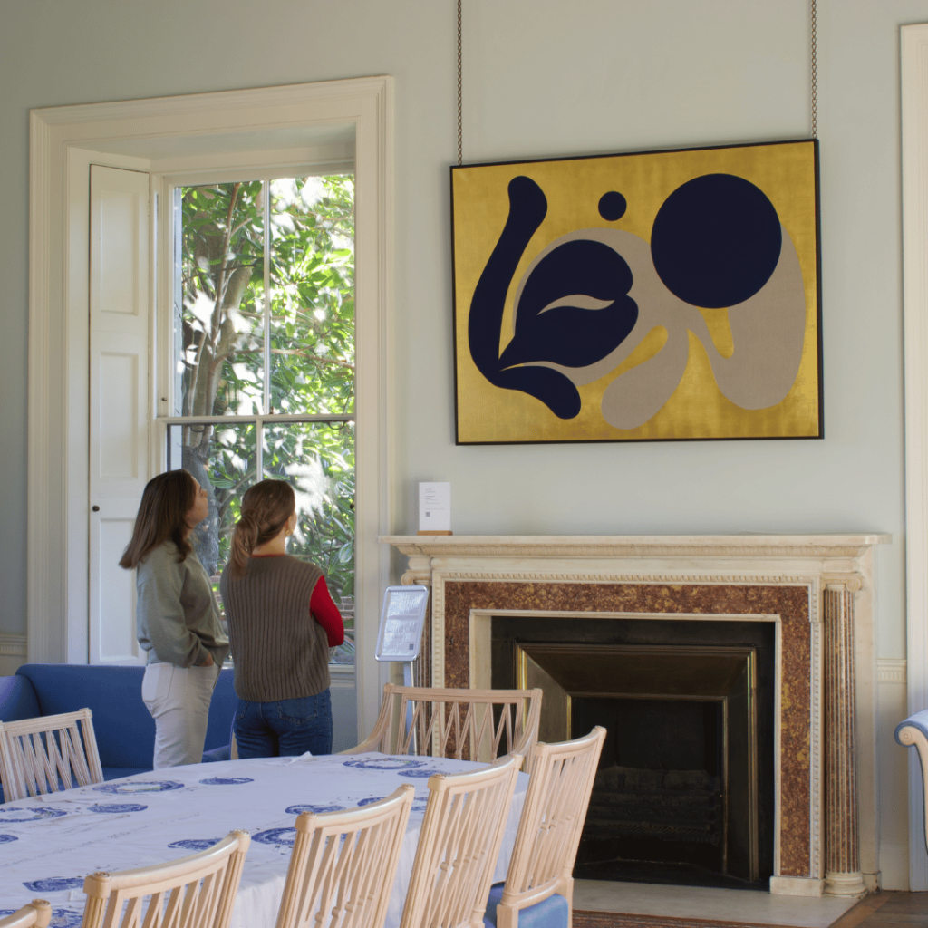 Visitors admire a bold, abstract artwork in the Georgian dining room, blending classic architecture with contemporary style.